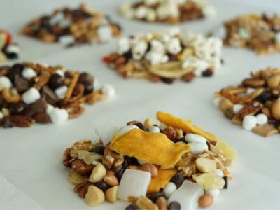 trail mix varieties in little piles against a white background