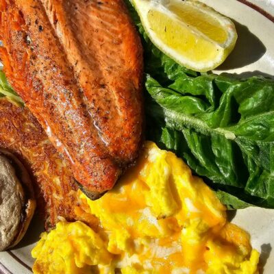A delicious breakfast plate of trout, eggs, and spinach