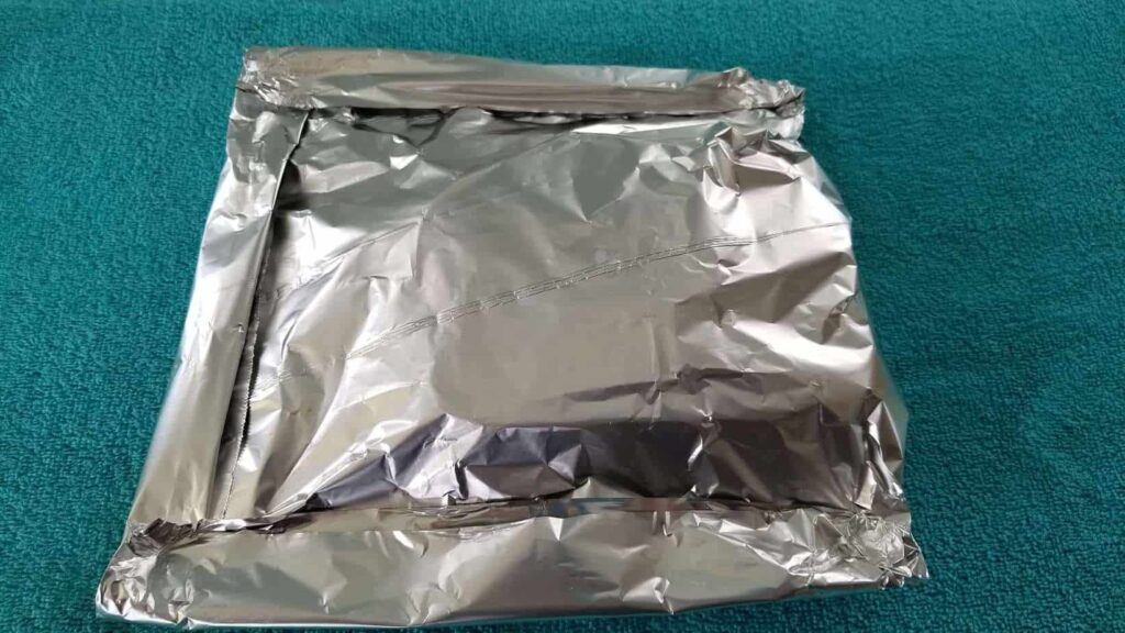 A packet of foil on a turquoise towel 