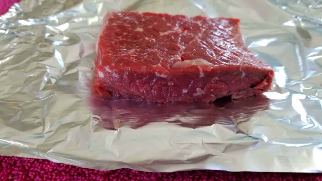 A rare steak on foil