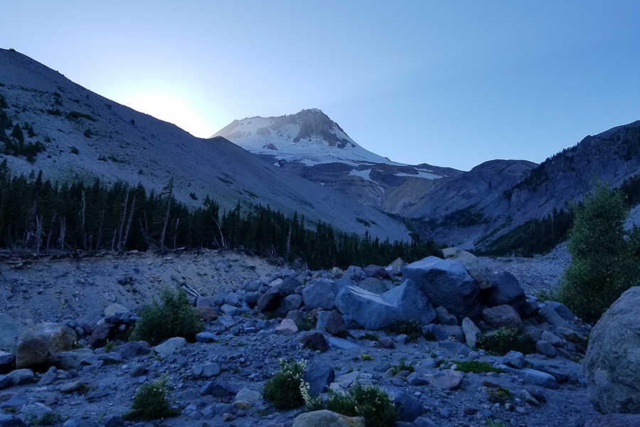 Mt. Hood at sunset. The mountain is at the top with fallen rocks laying around the bottom