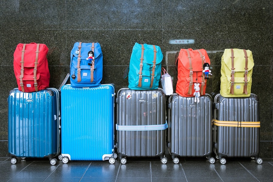 row of luggage, suitcases and backpacks