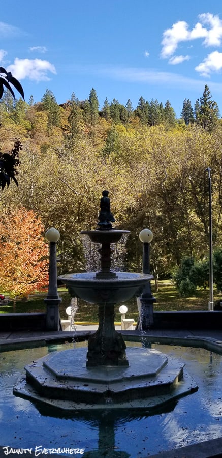 fountain in Lithia Park, Ashland, Oregon, trees with fall color in the background