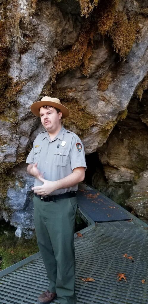 ranger standing outside cave entrance at Oregon Caves National Monument 