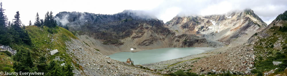 a lake at the base of a small glacier