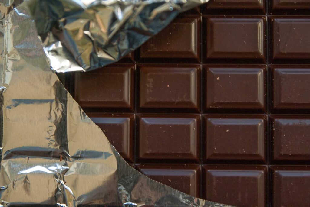 Chocolate bar with foil wrapper torn away