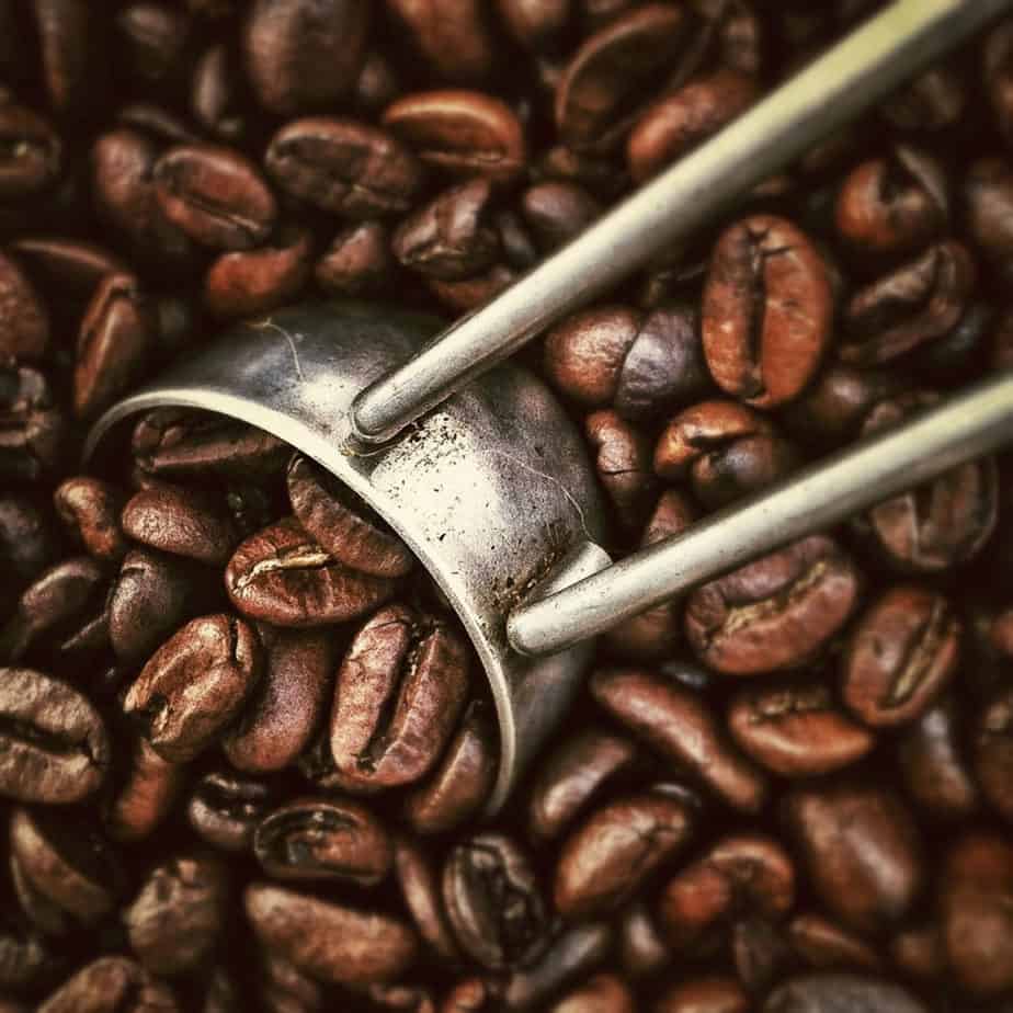 Scoop in a vat of coffee beans