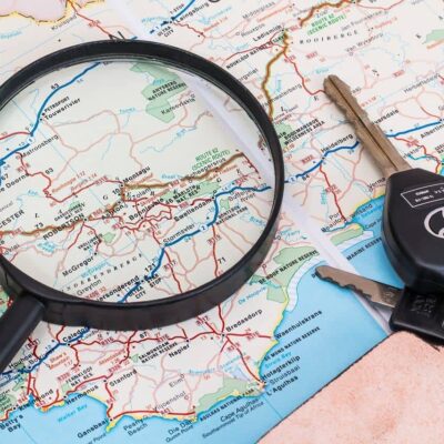 magnifying glass over a map with a set of keys to the side