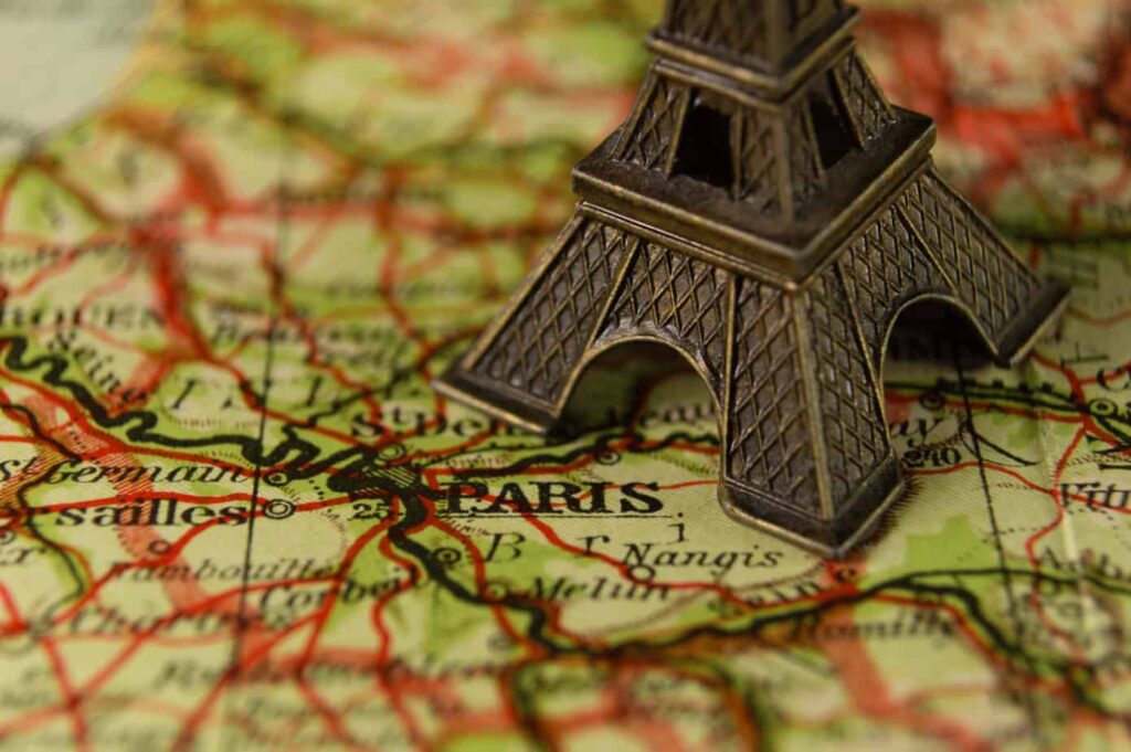 eiffle tower on top of a map of Paris