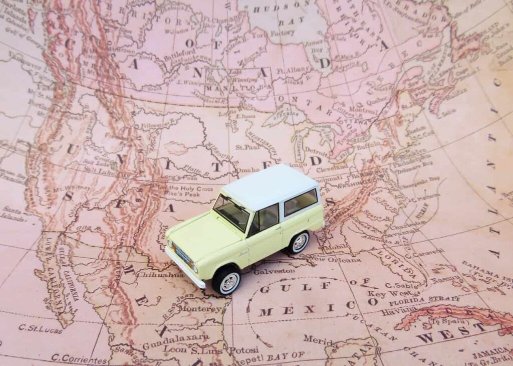 Mini toy car sitting on a map.