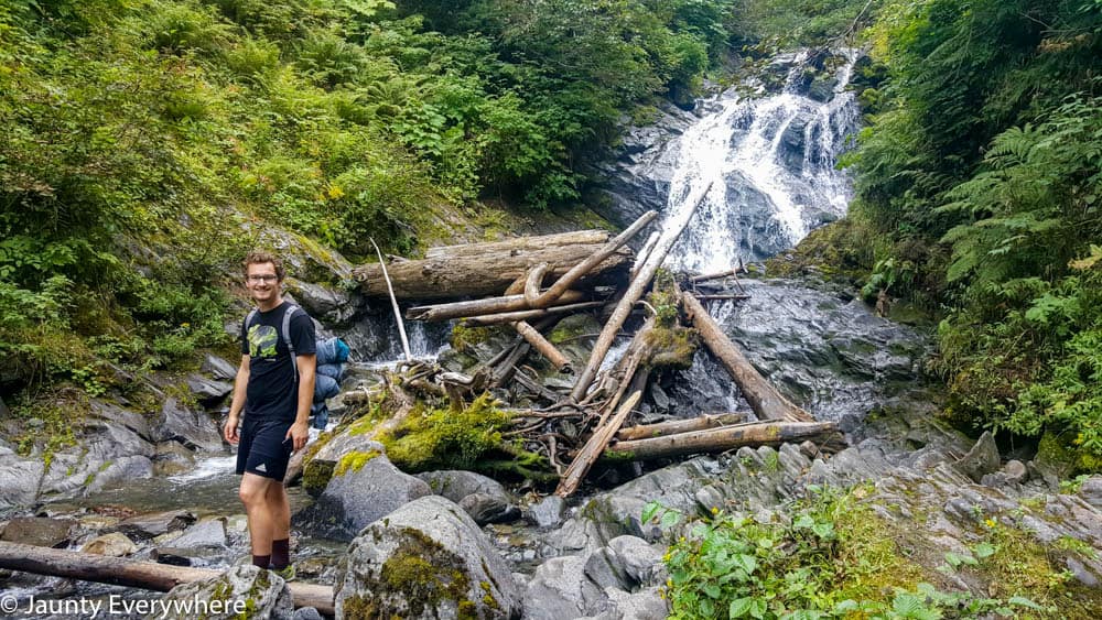 Jordan Stanton next to a waterfall.