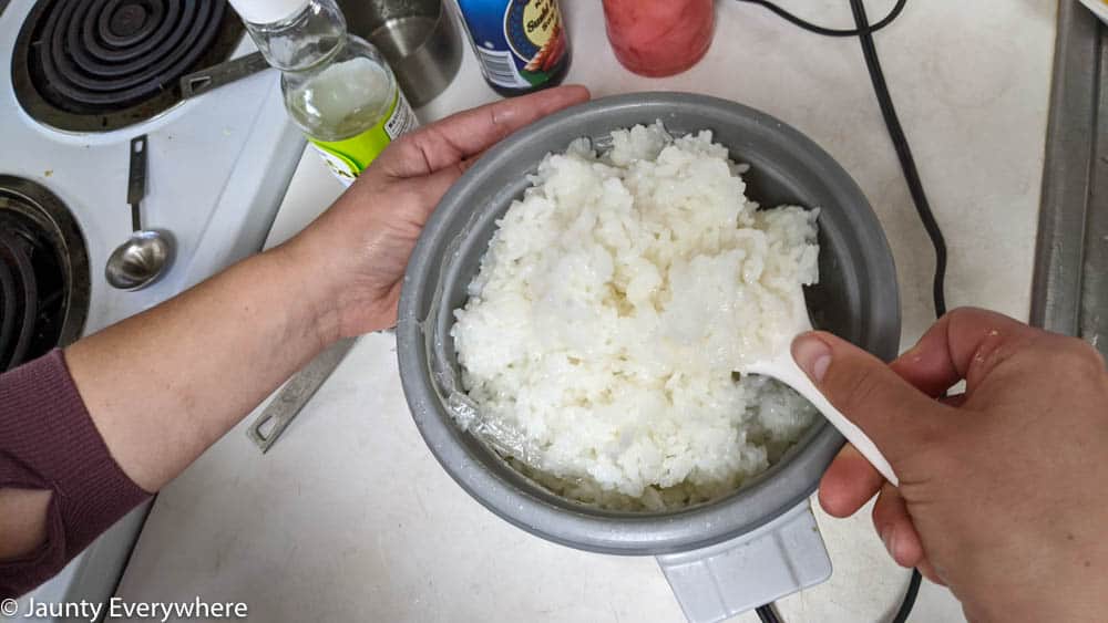 Fluffing rice for sushi making.