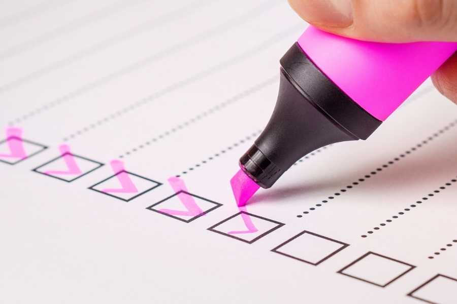 checklist with pink highlighter check marks