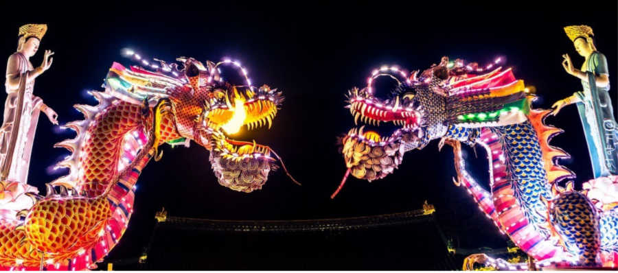 lighted dragon floats in a parade, explore cultures by attending festivals