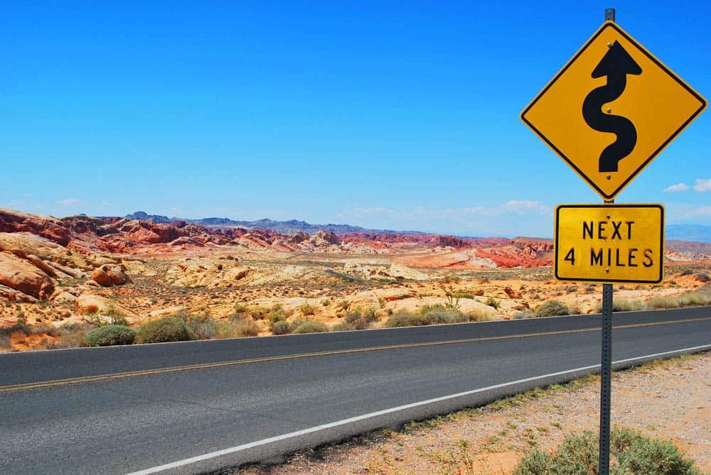 Road sign in the middle of a red rock desert.