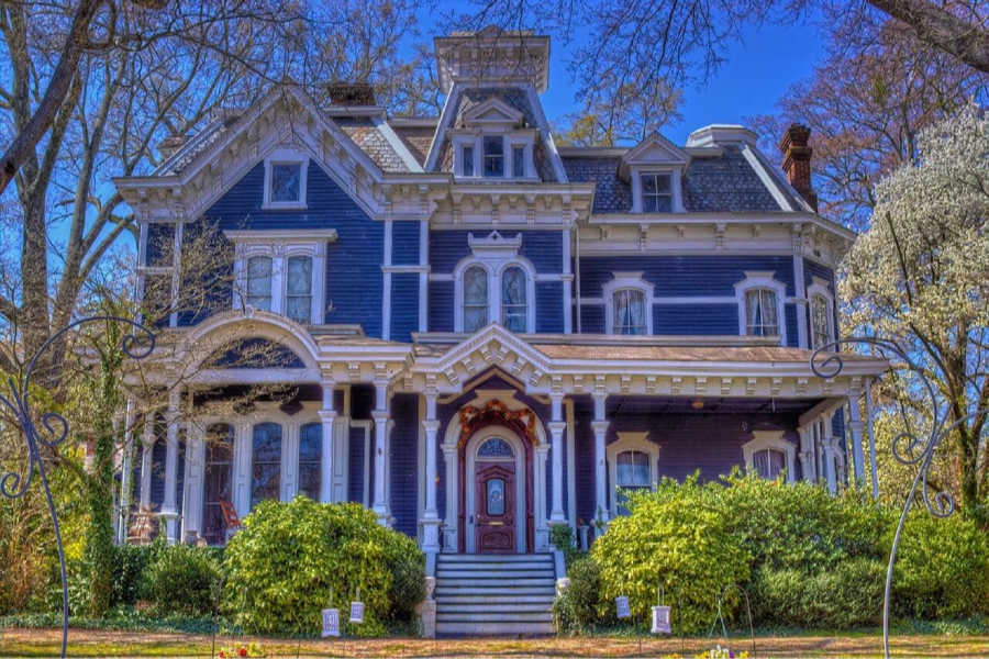 a blue victorian mansion turned into a bed and breakfast