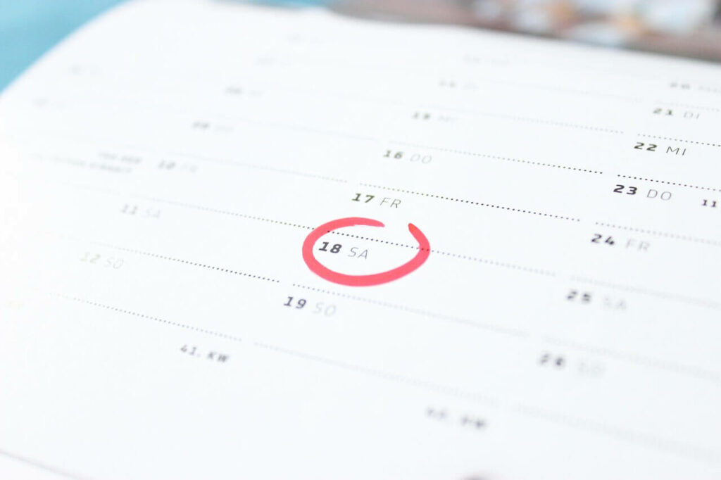 A calendar with a red circle around the day
