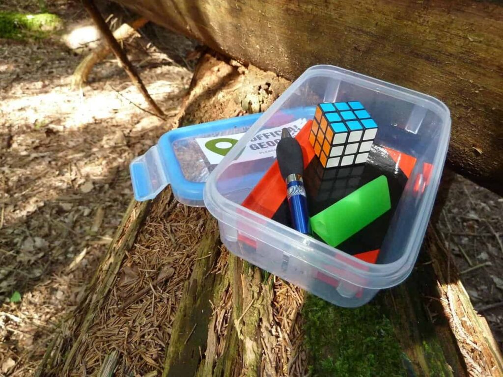 Geocache bin with trinkets and pen. How to get started geocaching.
