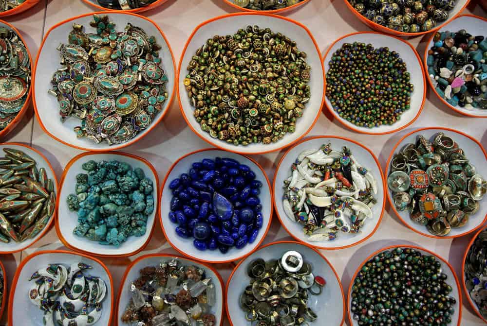 Bowls of brightly colored beads, buttons and rings.