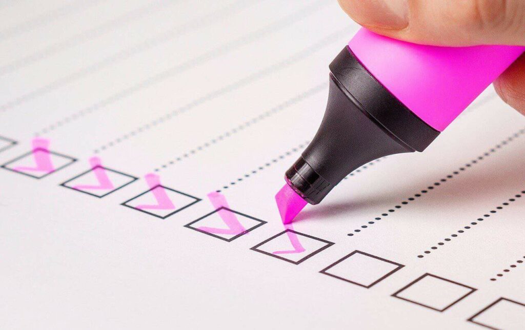 checklist with pink highlighter checkmarks