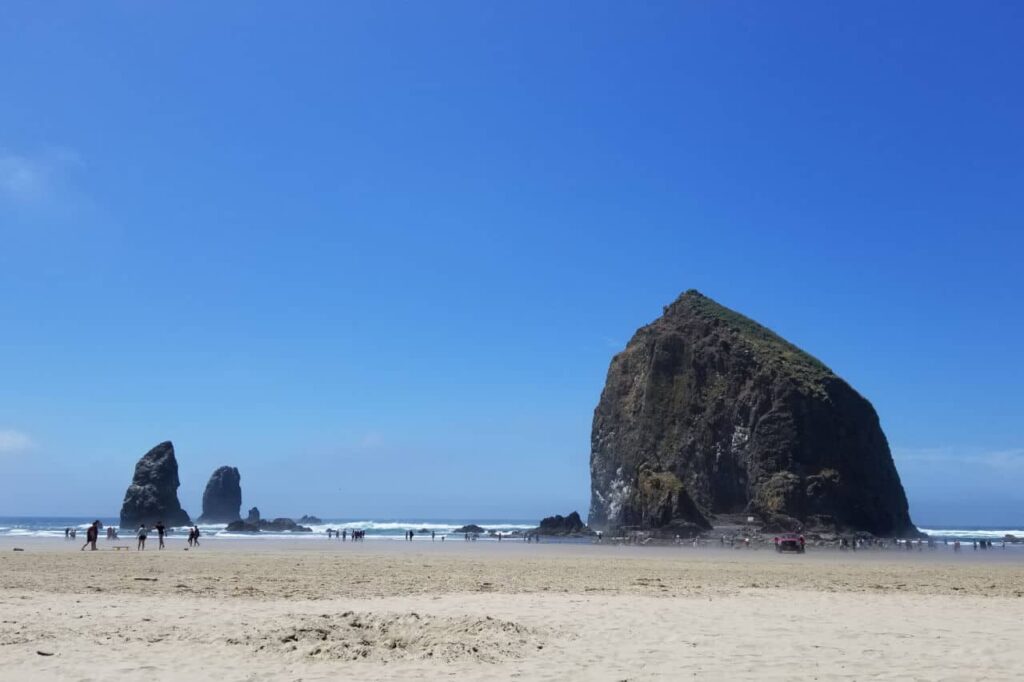 Haystack rock against a clear blue sky at Cannon Beach, Oregon