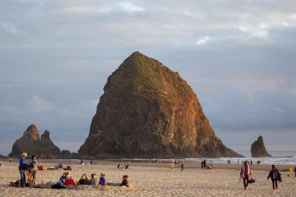 people enjoying the beach around Haystack Rock at Cannon Beach, Oregon