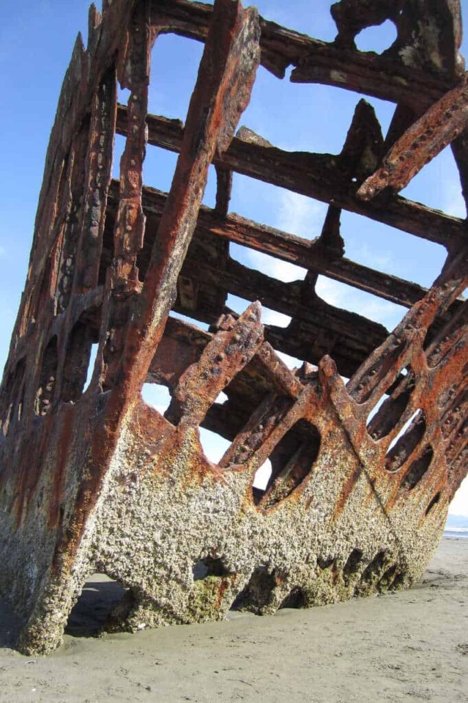 rusty ruins of the Peter Iredale Shipwreck on the beach at Fort Stevens State Park, Oregon