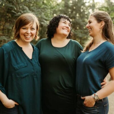 Bailey Bywater, Cheri Bywater, and Brittany Stanton - creators of Jaunty Everywhere standing in a forest.