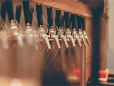 beer taps lined up against a stainless steel background