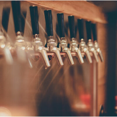 beer taps lined up against a stainless steel background