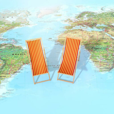 red and yellow striped lounge chairs sitting on a world map