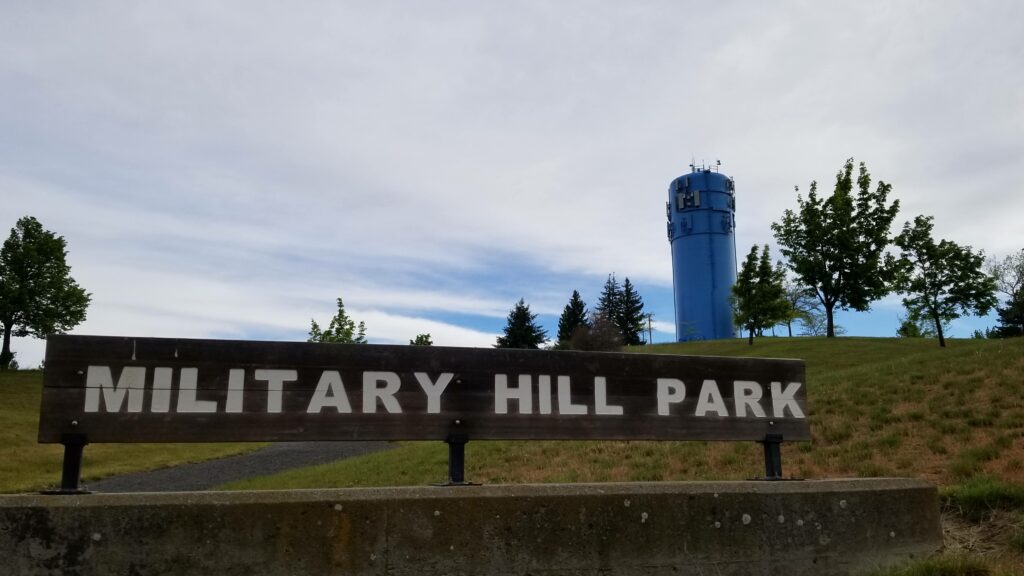 military hill park with blue water tower in the background