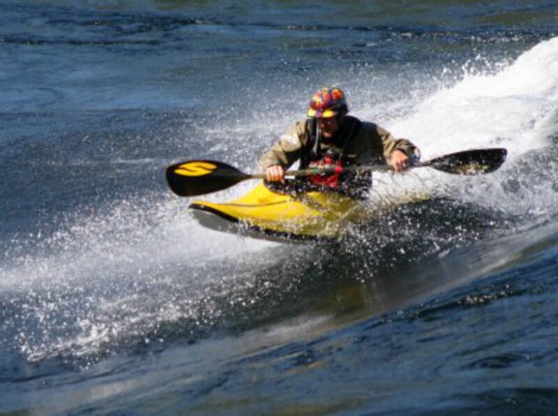 a white water kayaker tackles the Skookumchuck Rapids in a short yellow kayak