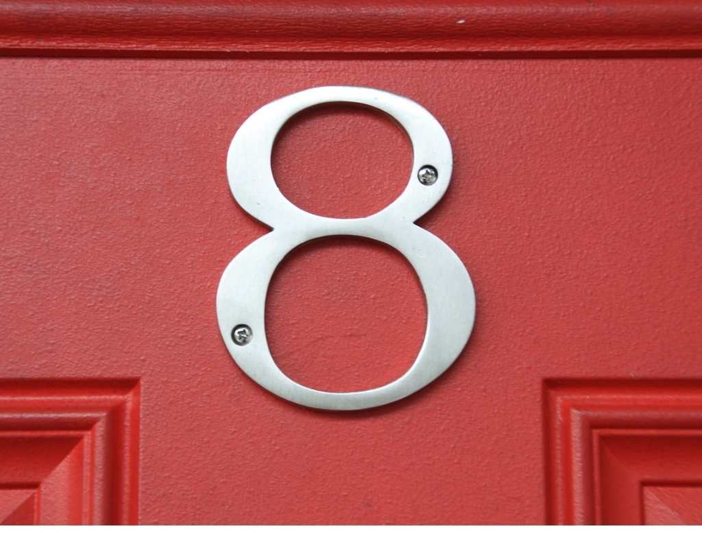 Silver letter eight on a red door