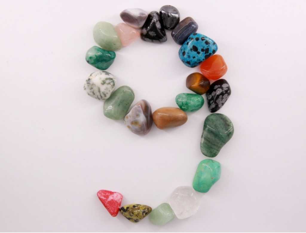numeral nine made out of agates and colored rocks
