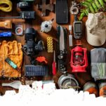 a flatlay of hiking equipment on a wood background