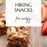 granola energy bars with oats and strawberries in the background