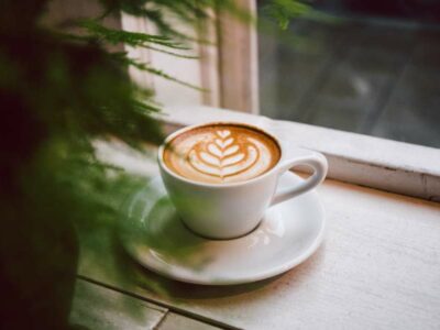 coffee in a white mug sitting in a windowsill