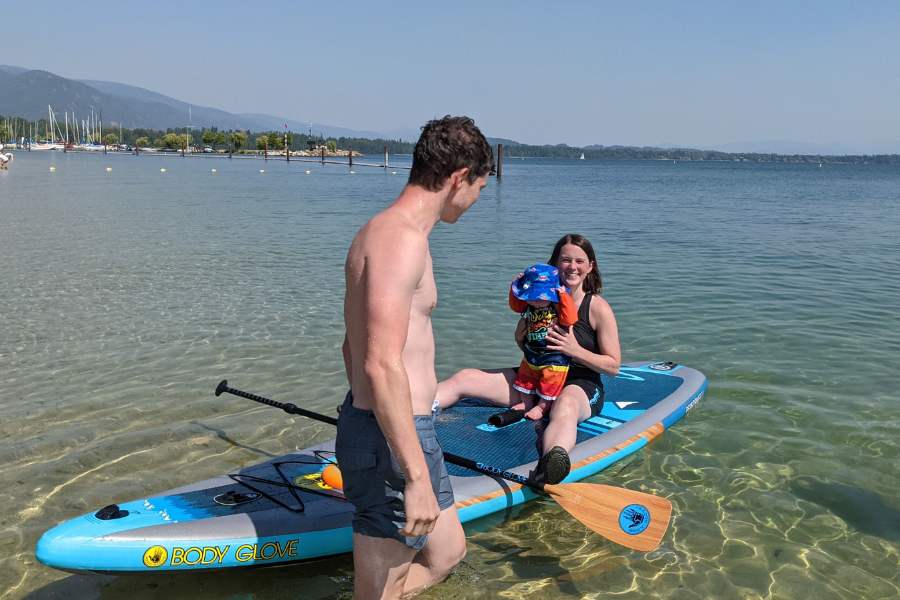 A family paddleboarding at City Beach in Sandpoint, Idaho