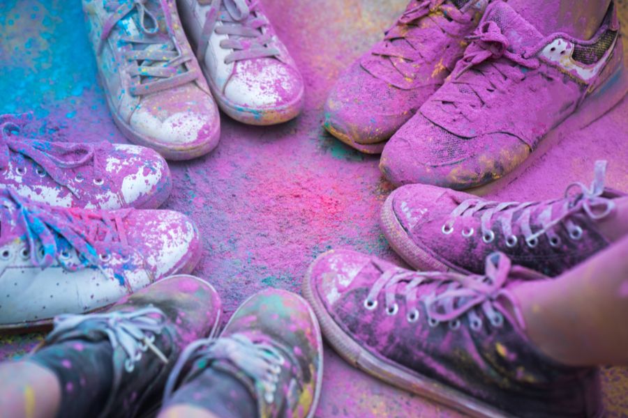shoes covered in pink powder after a color fun run