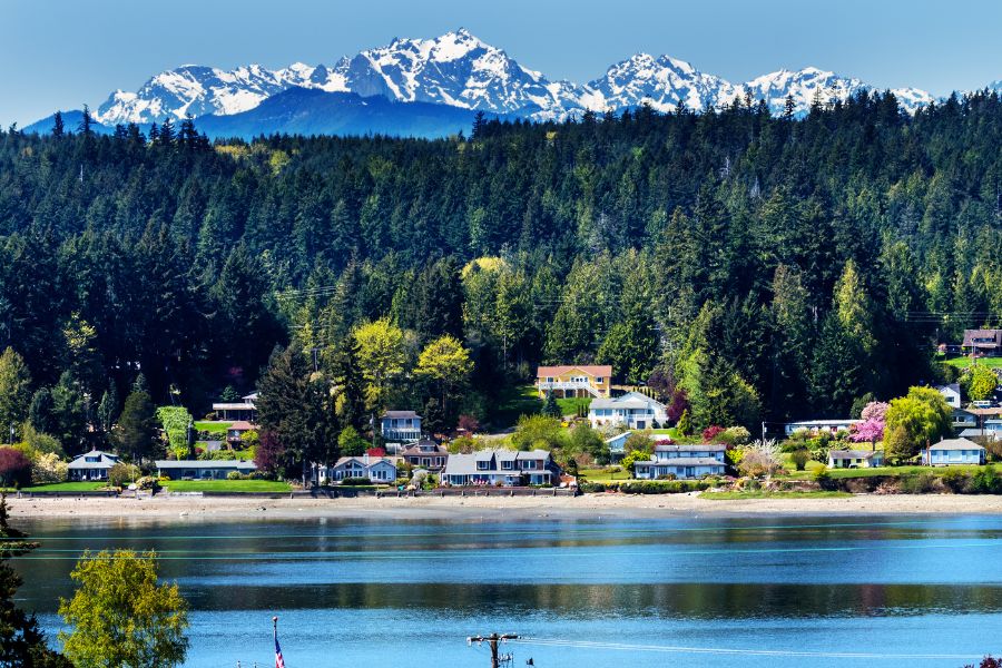 Poulsbo, Washington view of waterfront home, with mountain range in the background