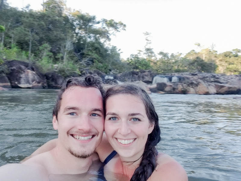 Man and woman swimming in a river.